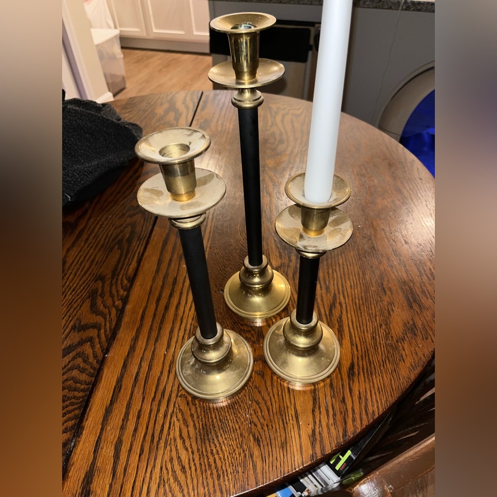 3 brass and black candle sticks (varying heights)